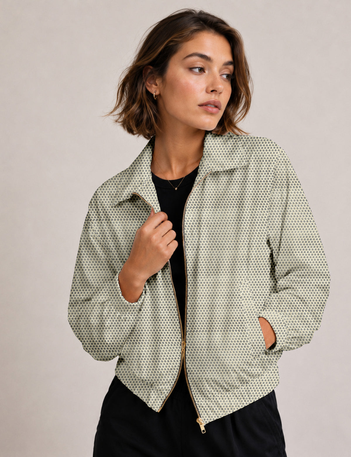 Woman wearing a yellow floral bomber jacket with front zipper, elastic cuffs, and side pockets, shown from front view