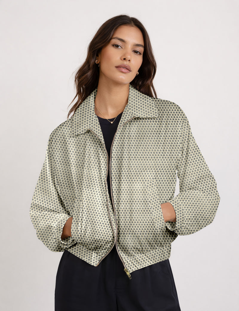 Brown floral bomber jacket with front zipper, elastic cuffs and hem, hanging on white hanger, red floral inner lining visible