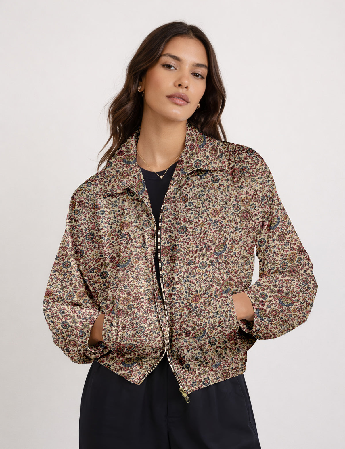 Brown floral bomber jacket with front zipper, elastic cuffs and hem, hanging on white hanger, red floral inner lining visible