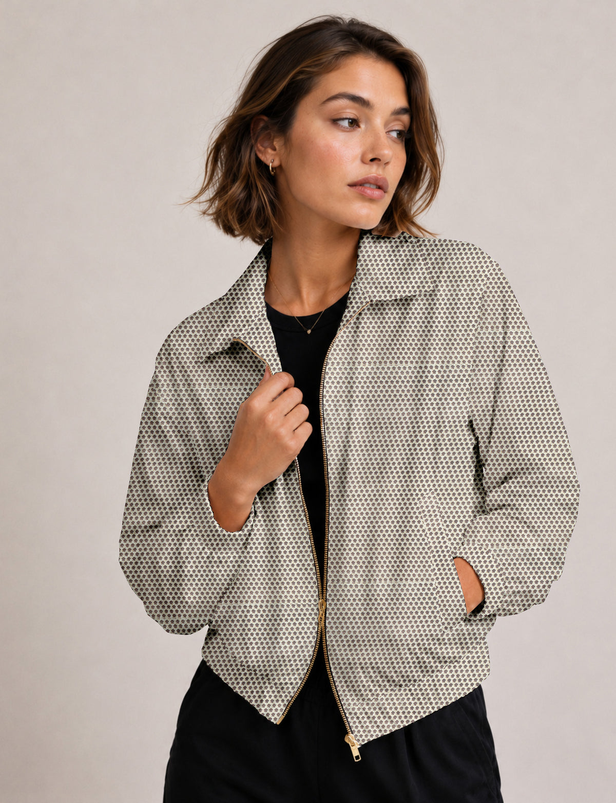 Brown floral bomber jacket with front zipper, elastic cuffs and hem, hanging on white hanger, red floral inner lining visible