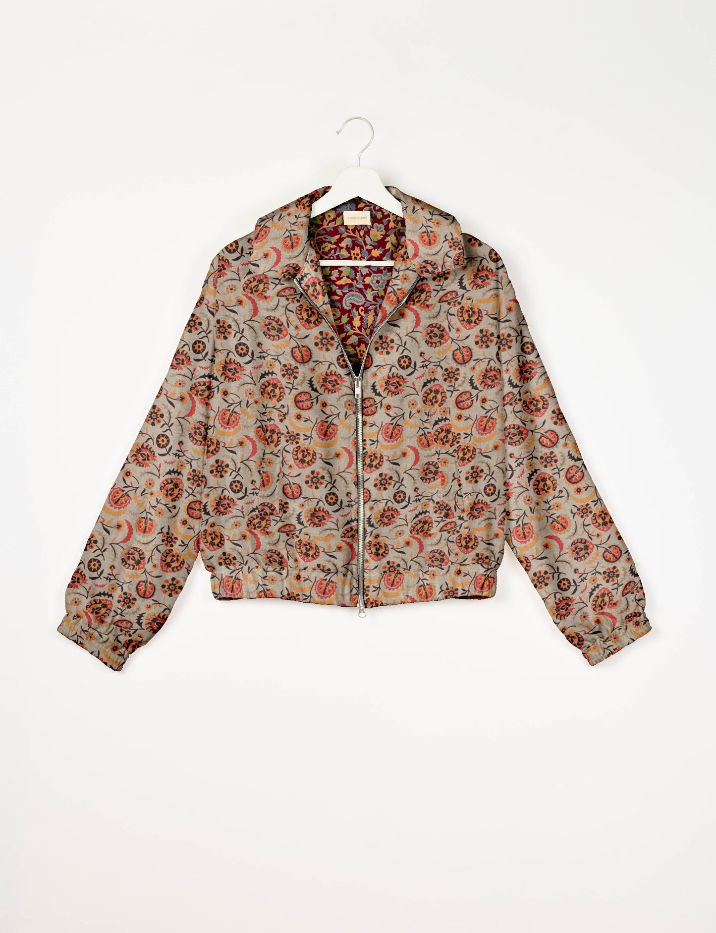 Upcycled Bomber Jacket made from recycled sari materials, featuring a cute cropped shape, elasticated hem and cuffs, and contrast sari print lining. Sustainable apparel promoting eco-friendly fashion and ethical clothing.