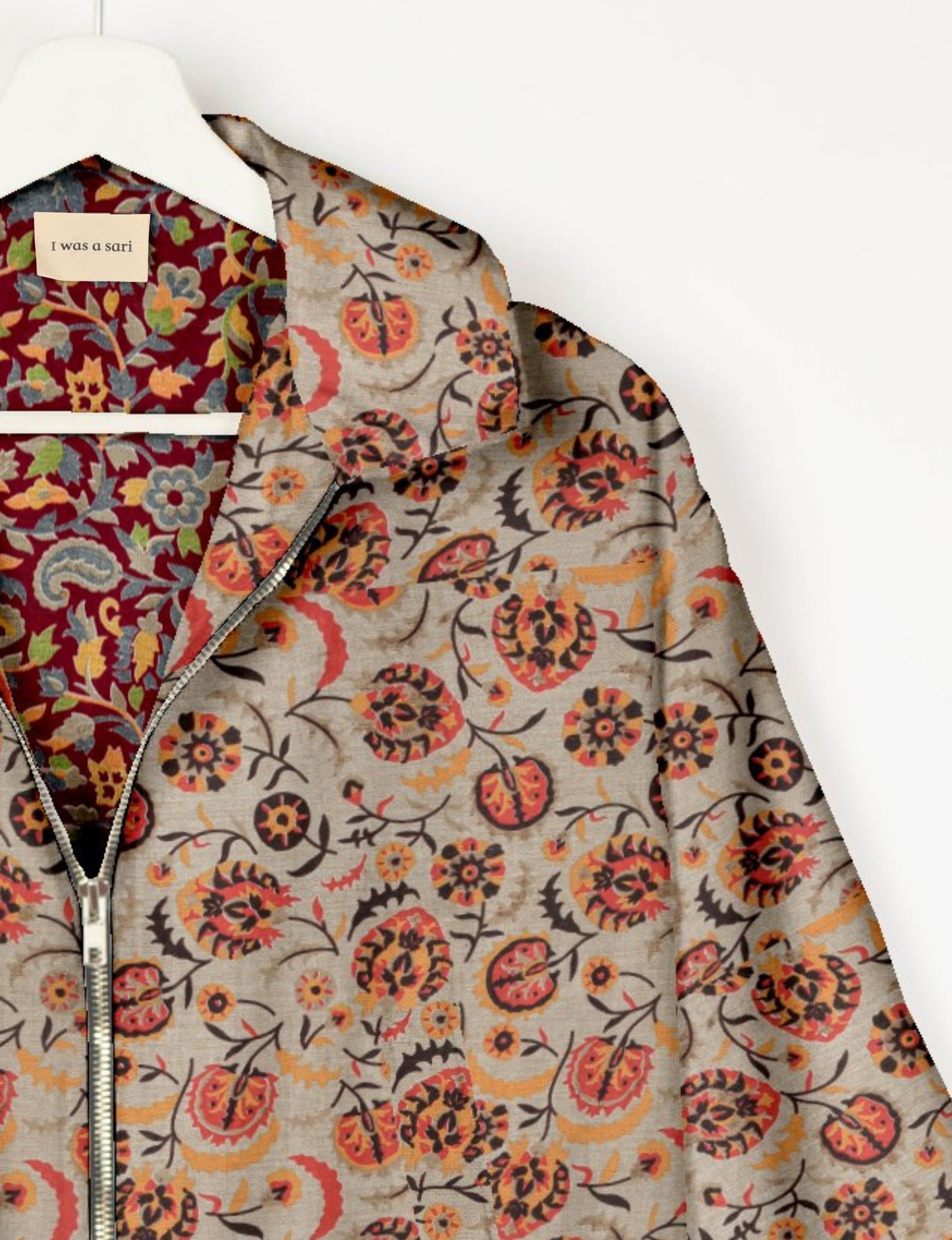 Upcycled Bomber Jacket made from recycled sari materials, featuring a cute cropped shape, elasticated hem and cuffs, and contrast sari print lining. Sustainable apparel promoting eco-friendly fashion and ethical clothing.