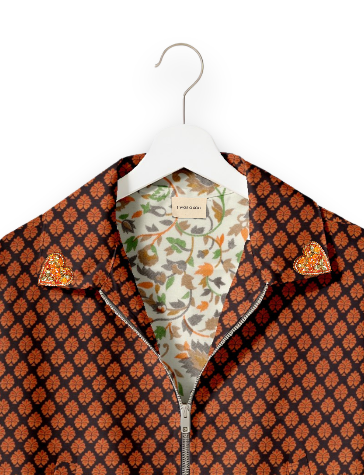 Black bomber jacket with orange leaf pattern, gold heart embellishments on collar, floral inner lining, and front zipper, on
