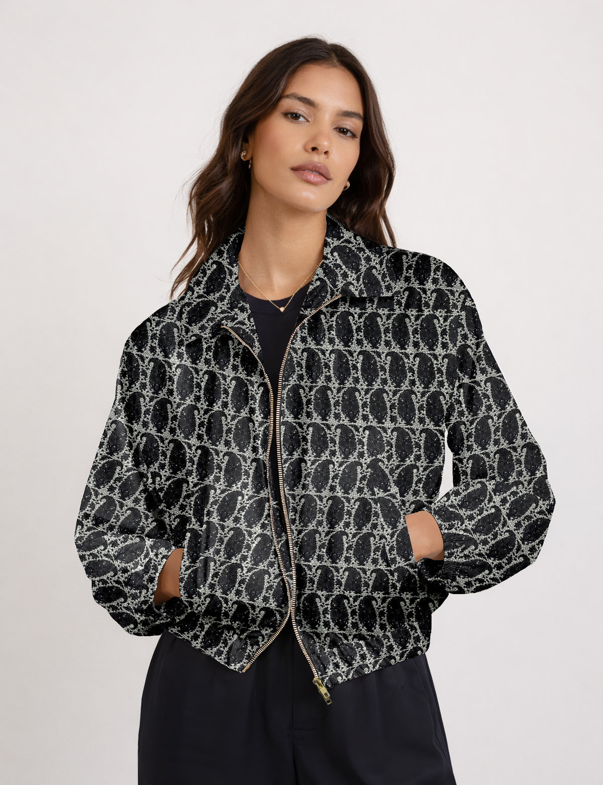 Brown floral bomber jacket with front zipper, elastic cuffs and hem, hanging on white hanger, red floral inner lining visible