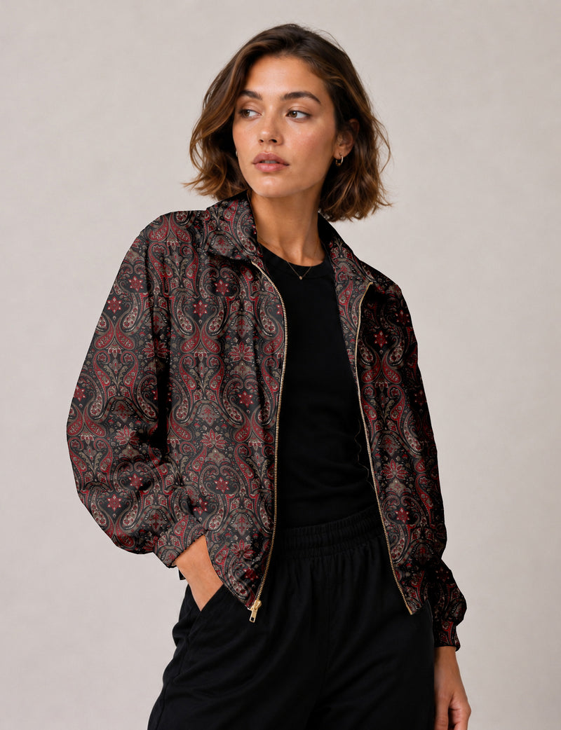 Brown floral bomber jacket with front zipper, elastic cuffs and hem, hanging on white hanger, red floral inner lining visible