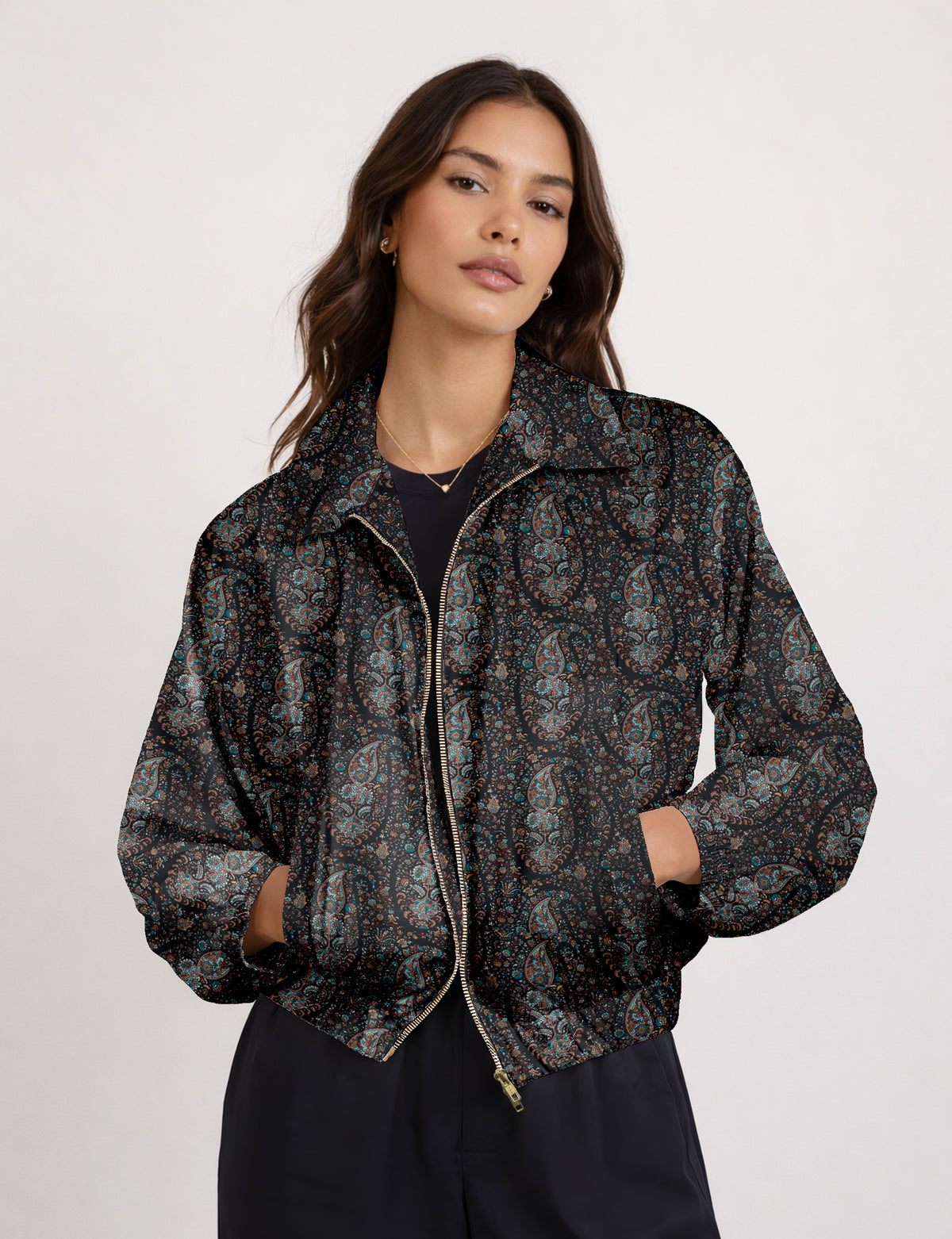 Woman wearing a yellow floral bomber jacket with front zipper, elastic cuffs, and side pockets, shown from front view
