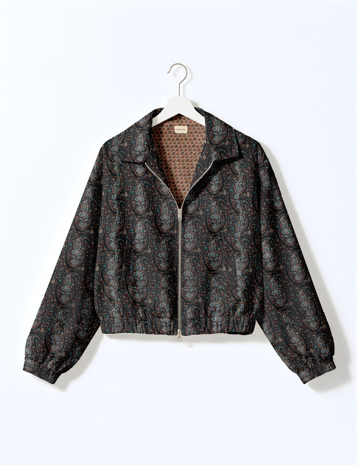 Brown floral bomber jacket with front zipper, elastic cuffs and hem, hanging on white hanger, red floral inner lining visible