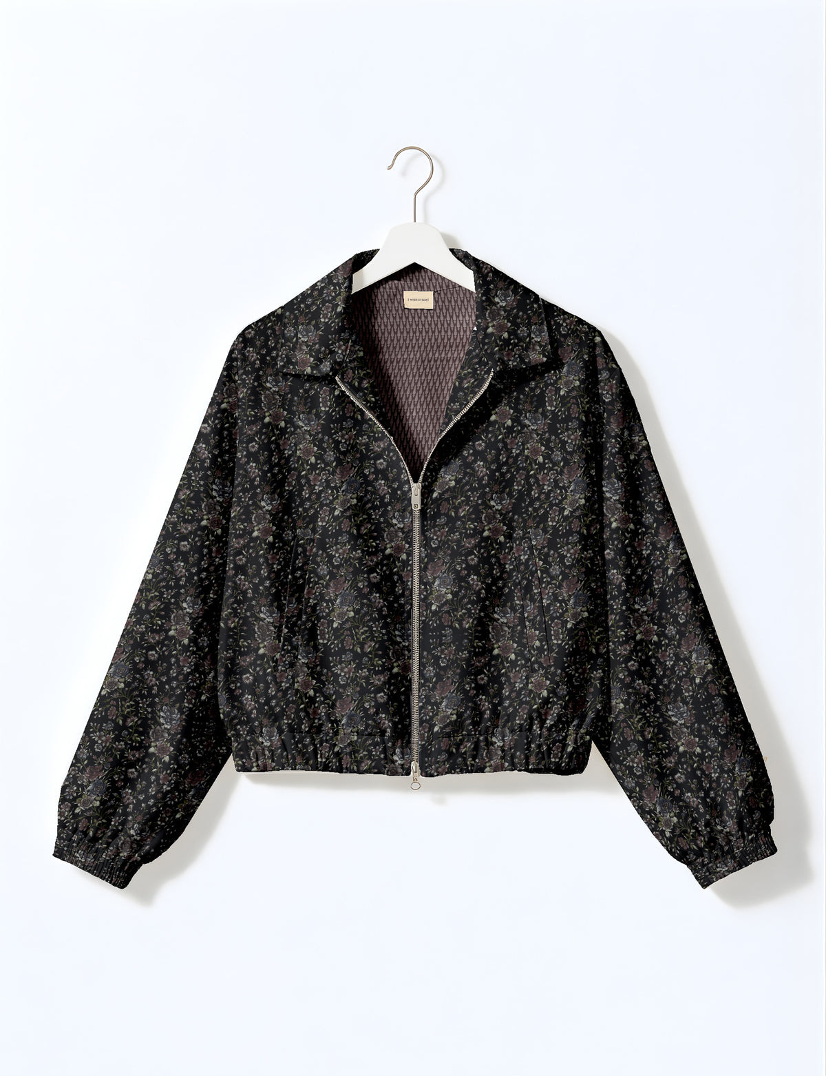 Woman wearing a yellow floral bomber jacket with front zipper, elastic cuffs, and side pockets, shown from front view