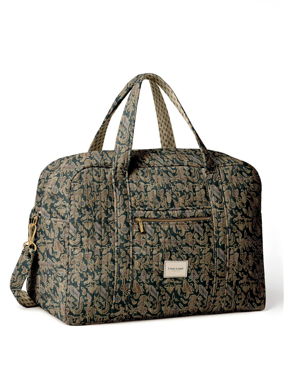 Brown quilted duffle bag with paisley pattern, front zip pocket, dual handles, and label reading "I was a sari"