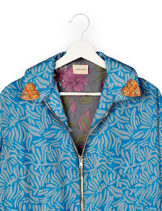 Make a bold statement with our Heart Drop Earrings, a symbol of conscious luxury and ethical fashion. Handcrafted using the intricate Aari embroidery technique, these earrings are made from upcycled sari fabric, embracing slow fashion and zero waste clothing. Elevate your look with sustainable apparel that supports fair trade fashion while reducing textile waste. Choose eco-friendly fashion that speaks of love, artistry, and responsibility.