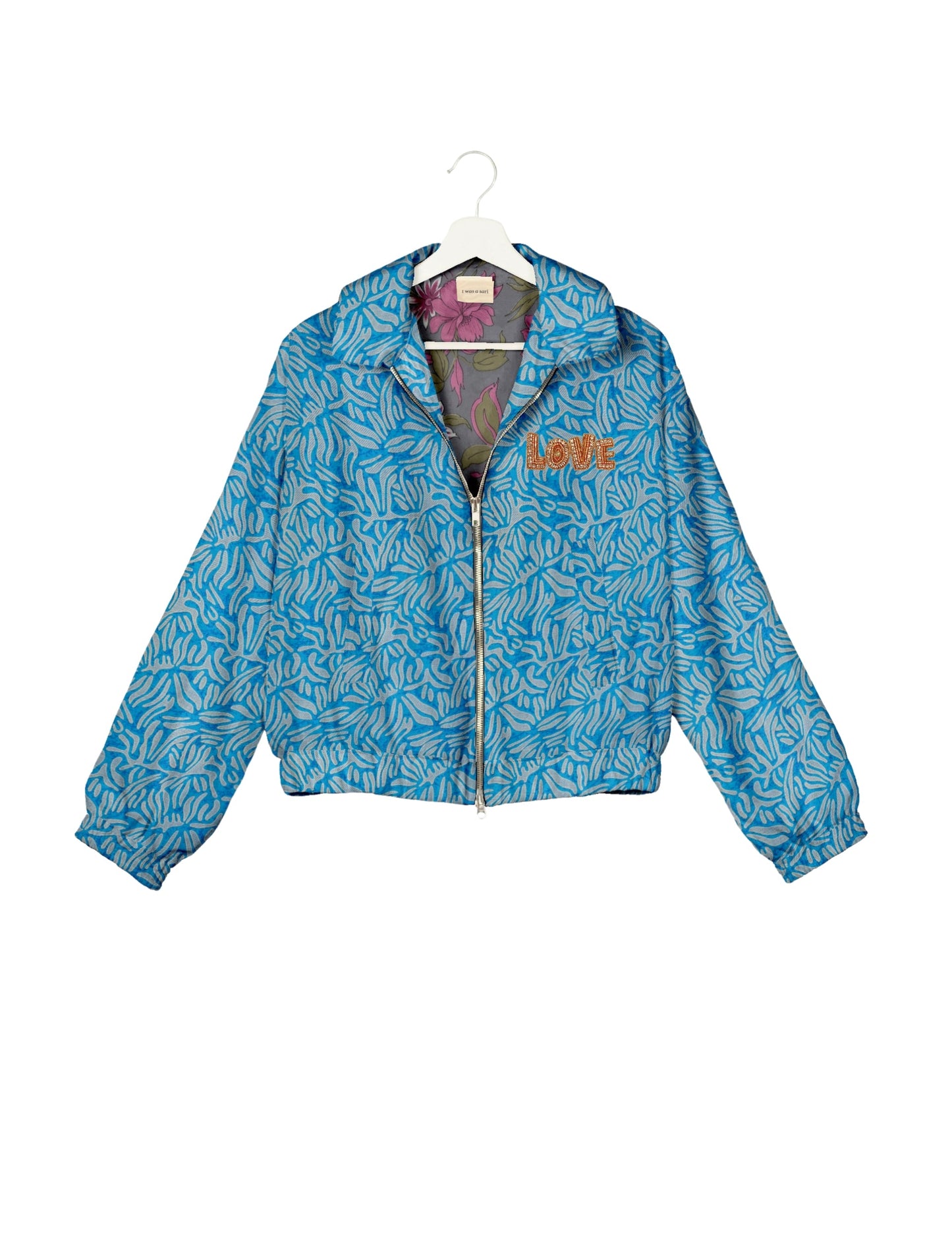 Love Bomber Jacket made from recycled fabric, featuring hand-stitched Aari embroidery. A unique piece of zero-waste clothing, part of the circular fashion movement. Designed with upcycled materials for a stylish yet environmentally friendly clothing choice.