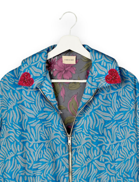 Make a bold statement with our Heart Drop Earrings, a symbol of conscious luxury and ethical fashion. Handcrafted using the intricate Aari embroidery technique, these earrings are made from upcycled sari fabric, embracing slow fashion and zero waste clothing. Elevate your look with sustainable apparel that supports fair trade fashion while reducing textile waste. Choose eco-friendly fashion that speaks of love, artistry, and responsibility.