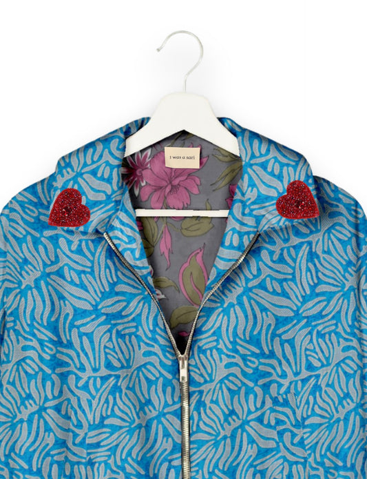 Make a bold statement with our Heart Drop Earrings, a symbol of conscious luxury and ethical fashion. Handcrafted using the intricate Aari embroidery technique, these earrings are made from upcycled sari fabric, embracing slow fashion and zero waste clothing. Elevate your look with sustainable apparel that supports fair trade fashion while reducing textile waste. Choose eco-friendly fashion that speaks of love, artistry, and responsibility.