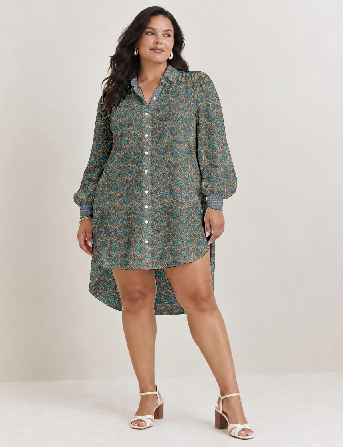 High low shirt with a relaxed fit, button-down front, classic collar, gathered shoulders and full-length blouson sleeves.