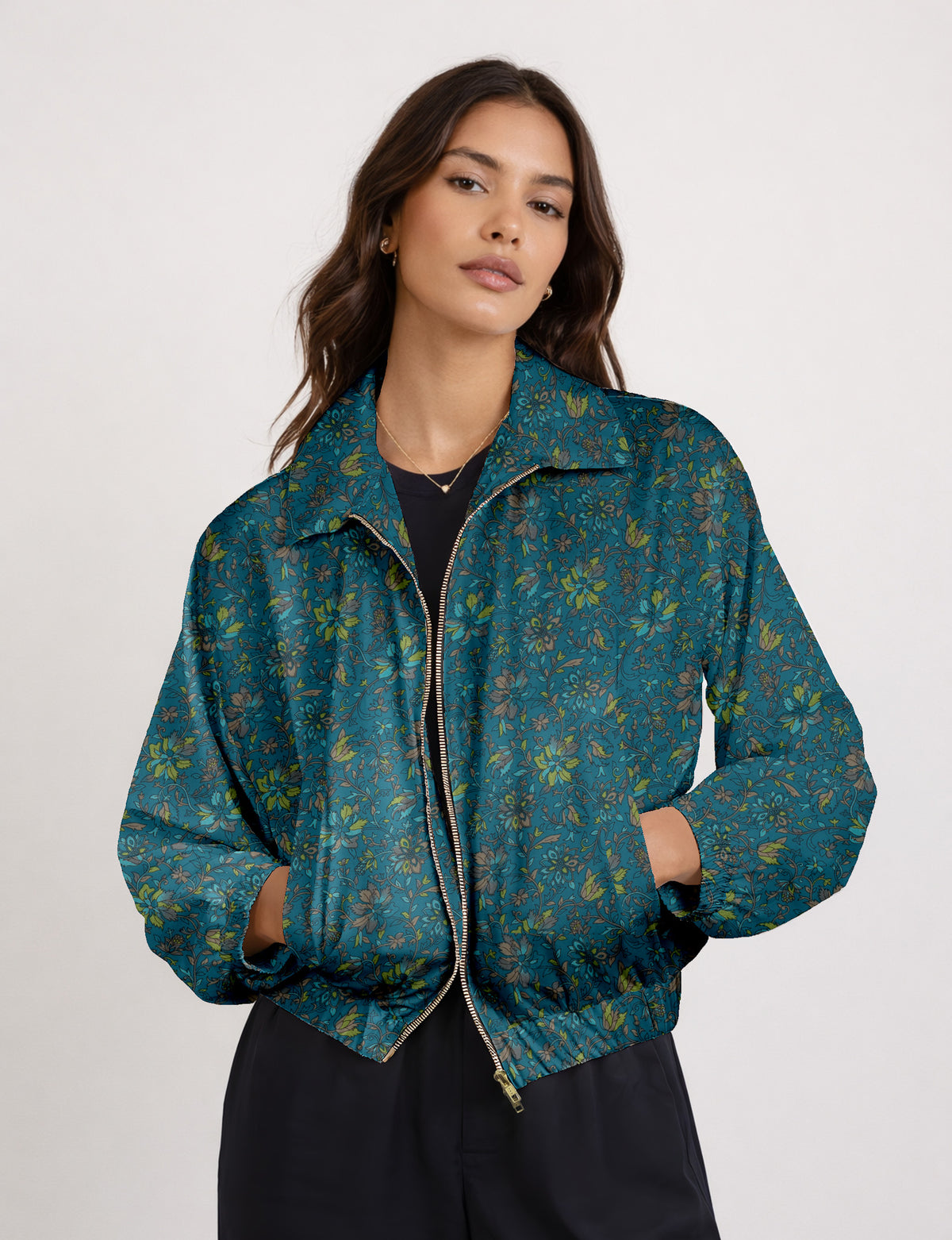 Brown floral bomber jacket with front zipper, elastic cuffs and hem, hanging on white hanger, red floral inner lining visible