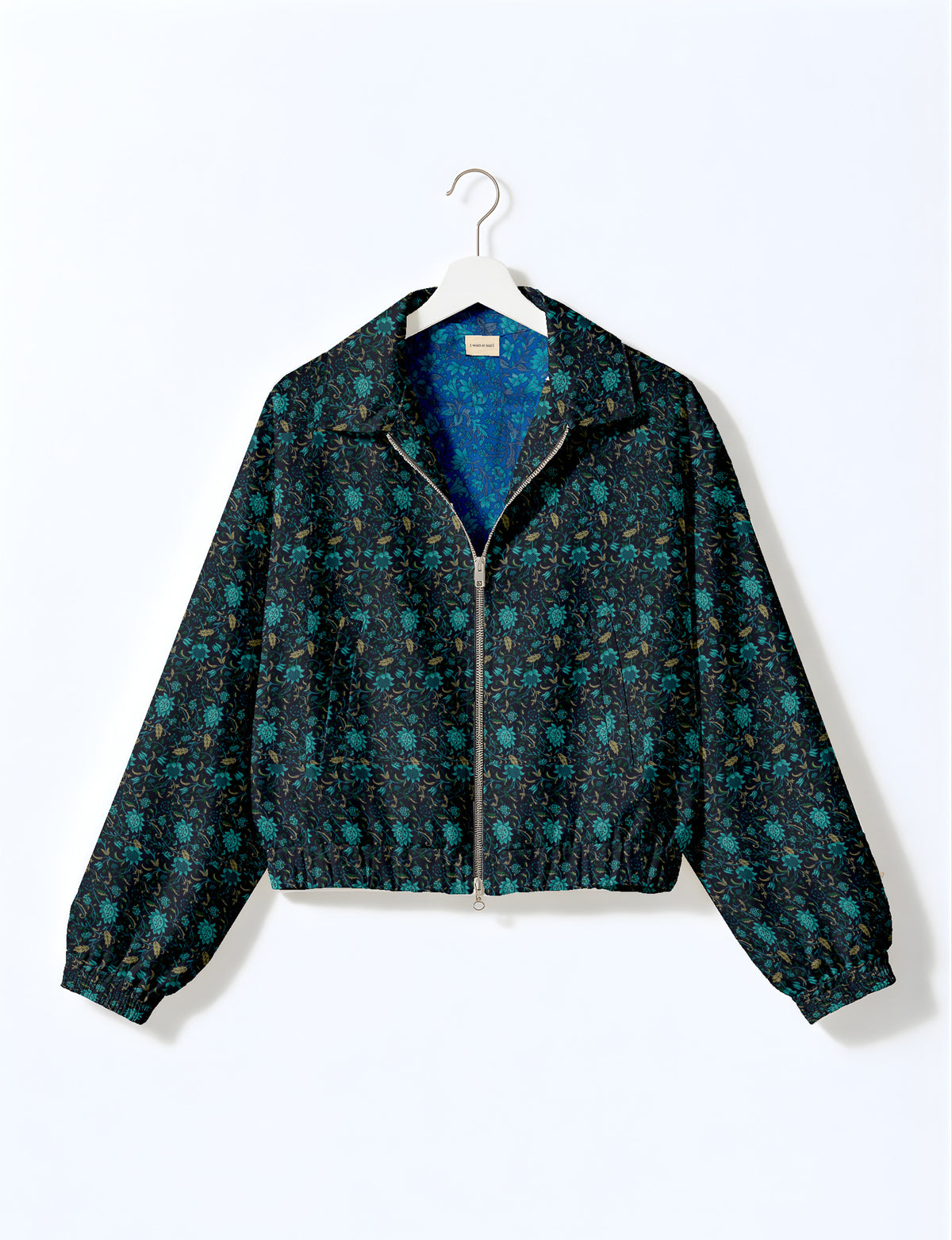 Woman wearing a yellow floral bomber jacket with front zipper, elastic cuffs, and side pockets, shown from front view