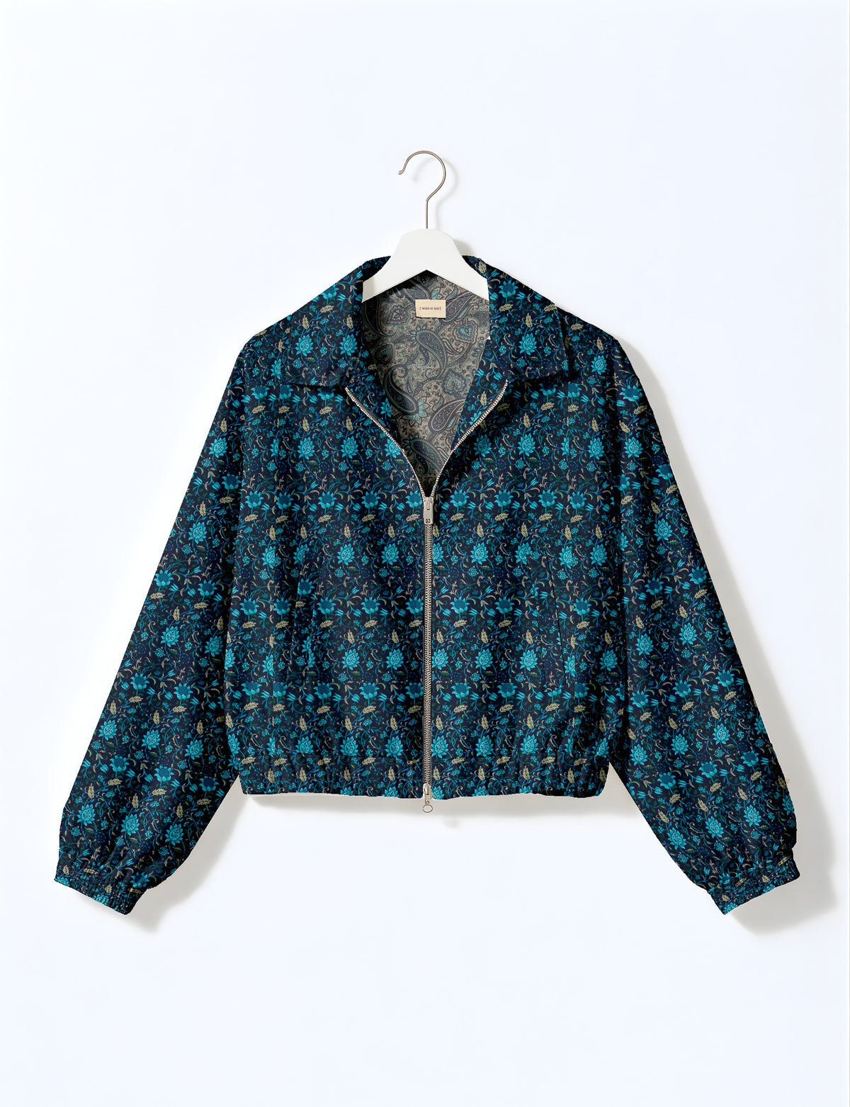 Woman wearing a yellow floral bomber jacket with front zipper, elastic cuffs, and side pockets, shown from front view