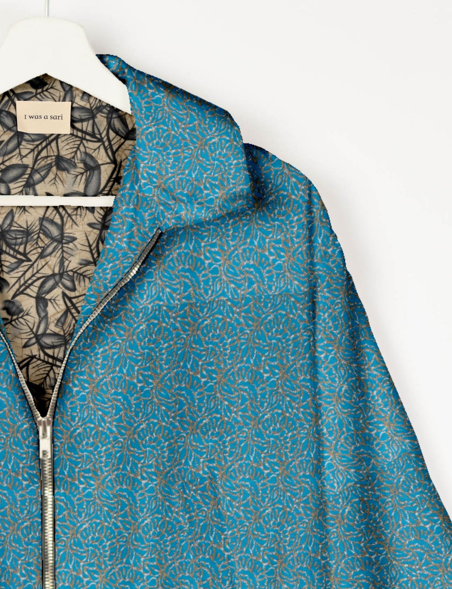Upcycled Bomber Jacket made from recycled sari materials, featuring a cute cropped shape, elasticated hem and cuffs, and contrast sari print lining. Sustainable apparel promoting eco-friendly fashion and ethical clothing.