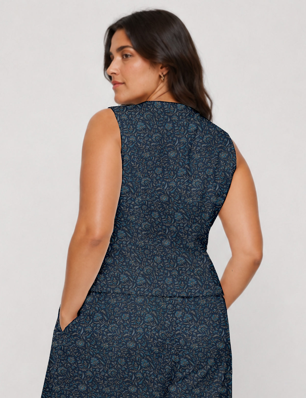 Women's fitted waistcoat with V-neck, single-breasted button closure, tailored silhouette, and pointed hem in sustainable fashion.