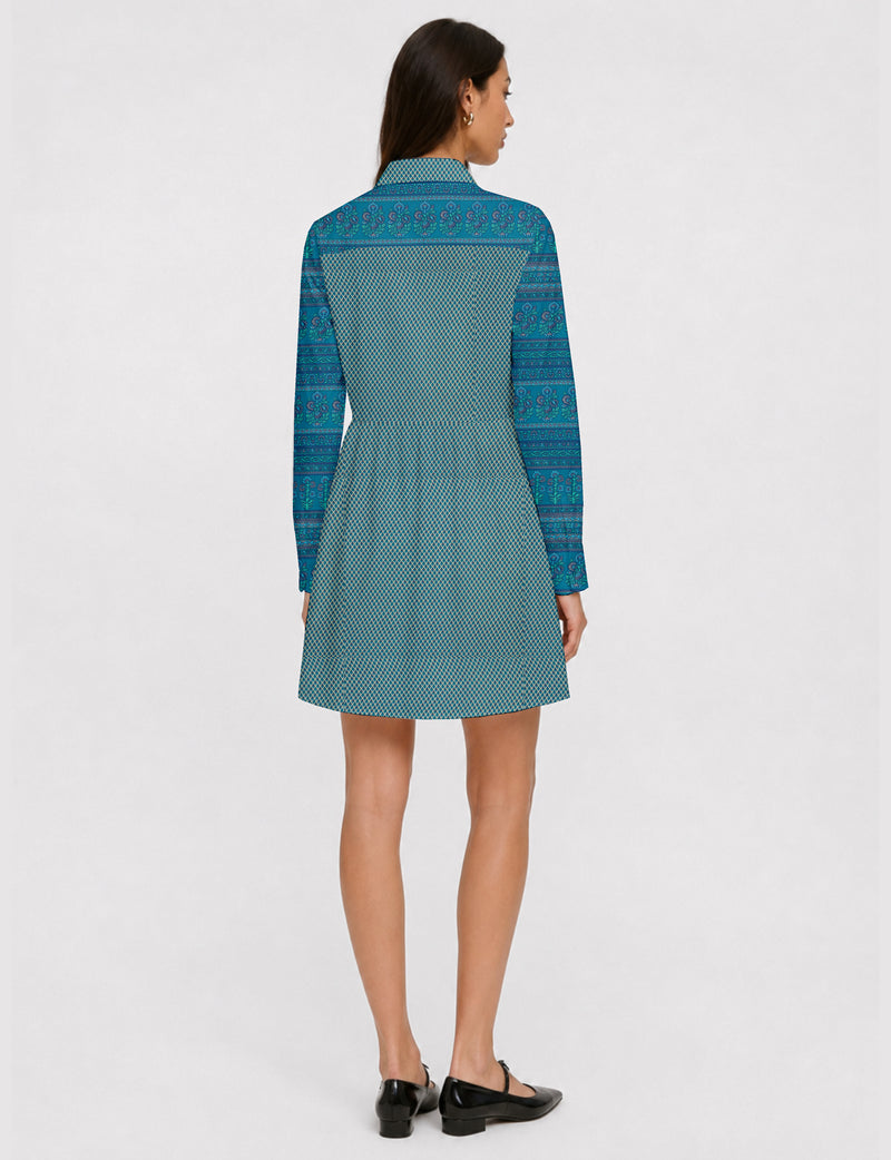 Short shirt dress with a relaxed A-line silhouette, point collar, partial button placket, gathered waist, side pockets, and full-length cuffed sleeves.
