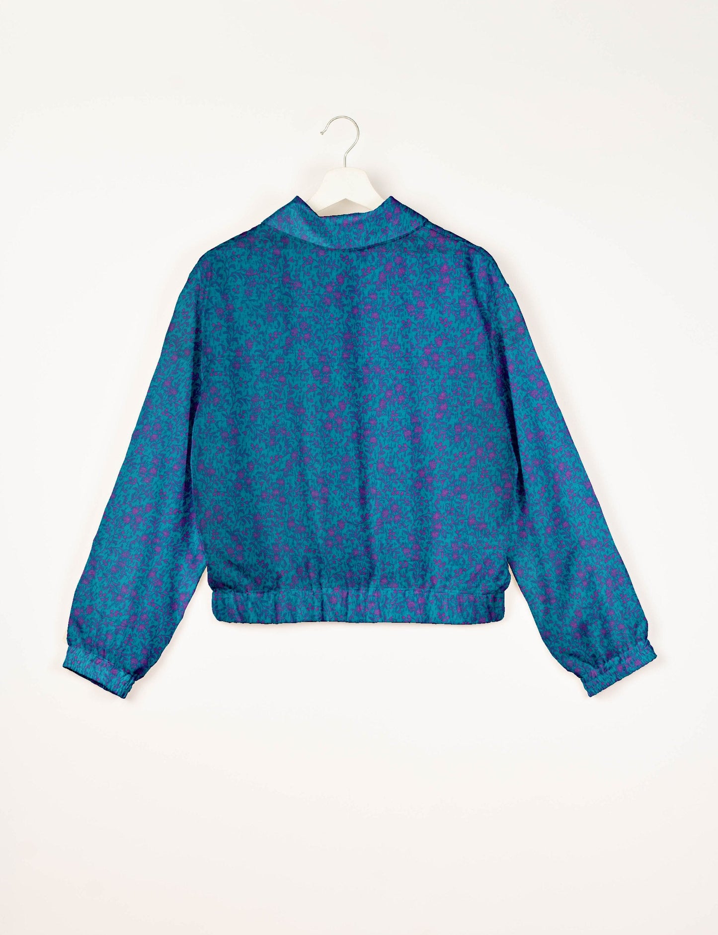 Upcycled Bomber Jacket made from recycled sari materials, featuring a cute cropped shape, elasticated hem and cuffs, and contrast sari print lining. Sustainable apparel promoting eco-friendly fashion and ethical clothing.