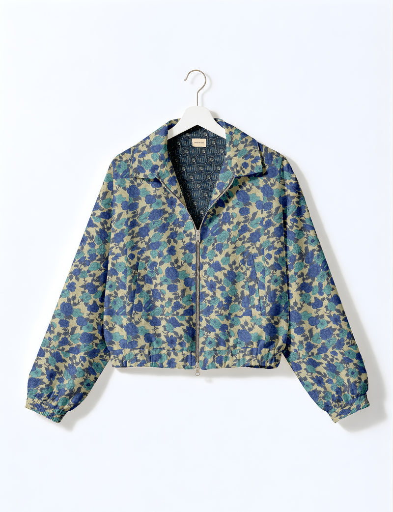 Woman wearing a yellow floral bomber jacket with front zipper, elastic cuffs, and side pockets, shown from front view