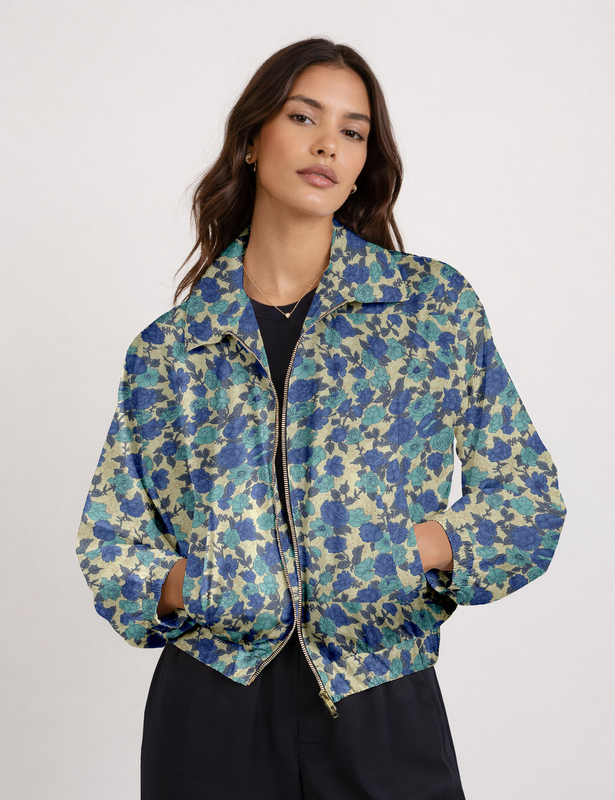 Brown floral bomber jacket with front zipper, elastic cuffs and hem, hanging on white hanger, red floral inner lining visible