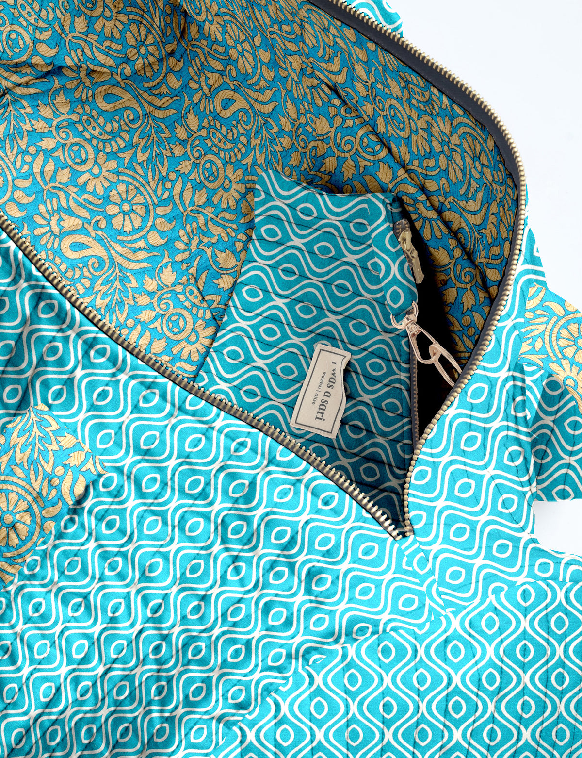 Quilted brown paisley bowling bag with gold zipper, floral interior lining, and interior key clip with label inside pocket