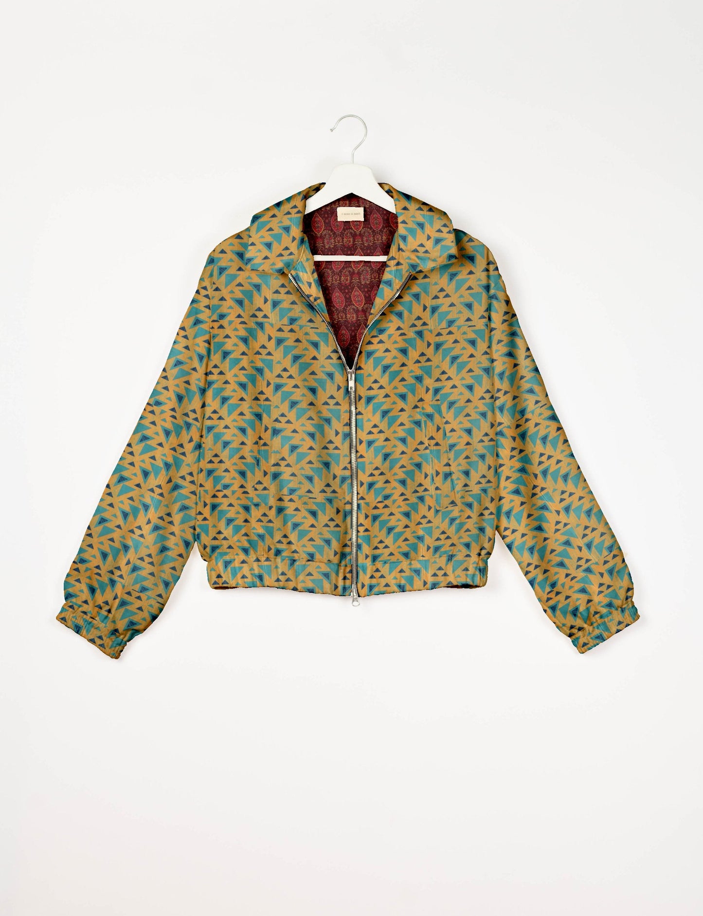 Stylish BOMBER JACKET, an upcycled clothing masterpiece with a cute cropped shape, elasticated details, and detachable metallic zipper. Contrast sari print lining adds a unique touch. Explore sustainable and eco-friendly fashion.