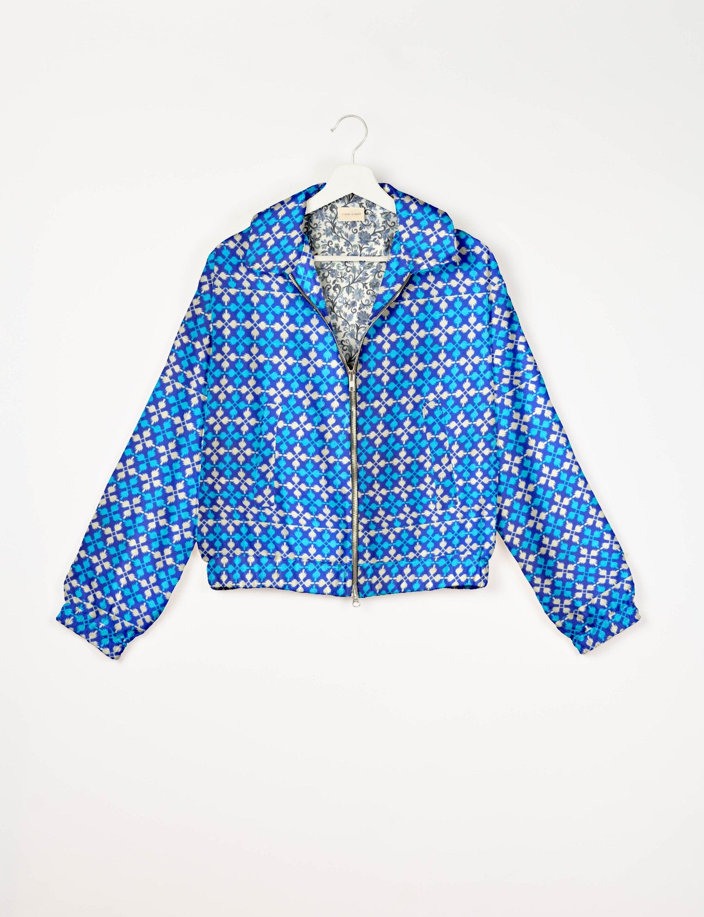Upcycled Bomber Jacket made from recycled sari materials, featuring a cute cropped shape, elasticated hem and cuffs, and contrast sari print lining. Sustainable apparel promoting eco-friendly fashion and ethical clothing.