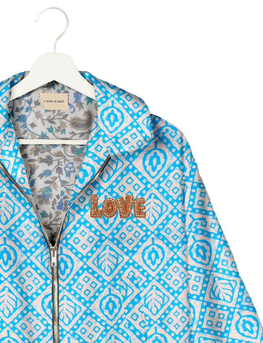 Love Bomber Jacket made from recycled fabric, featuring hand-stitched Aari embroidery. A unique piece of zero-waste clothing, part of the circular fashion movement. Designed with upcycled materials for a stylish yet environmentally friendly clothing choice.