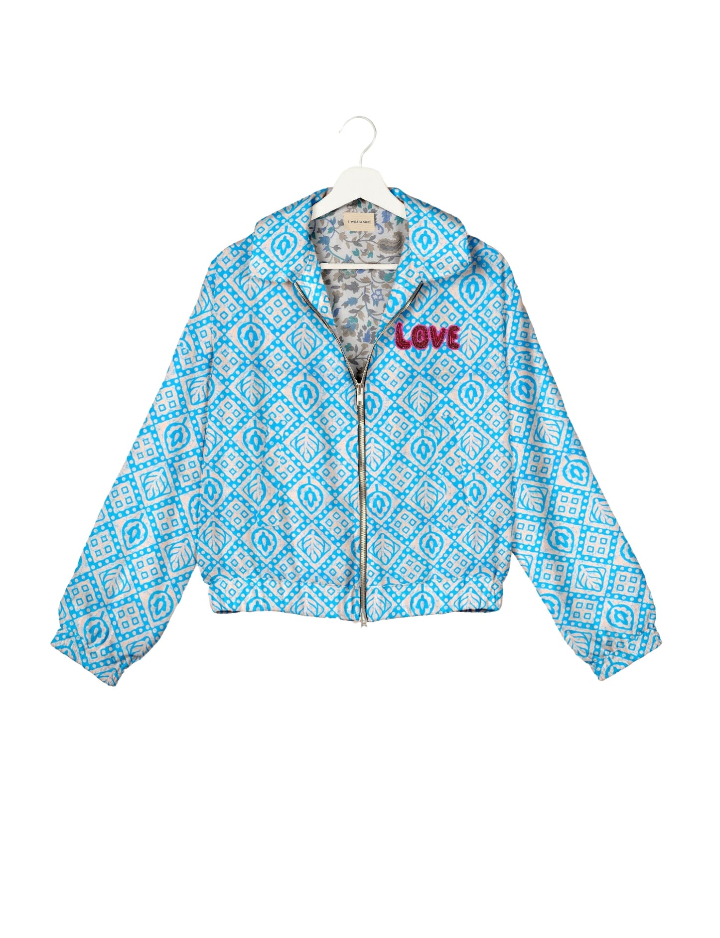 Love Bomber Jacket made from recycled fabric, featuring hand-stitched Aari embroidery. A unique piece of zero-waste clothing, part of the circular fashion movement. Designed with upcycled materials for a stylish yet environmentally friendly clothing choice.