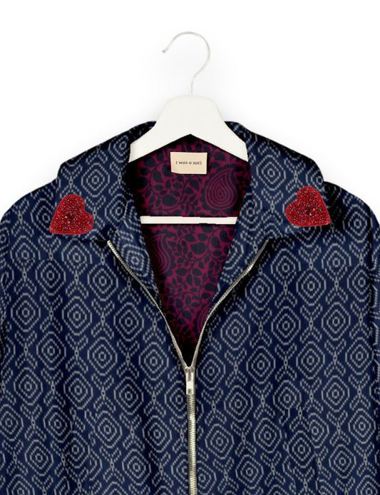 Make a bold statement with our Heart Drop Earrings, a symbol of conscious luxury and ethical fashion. Handcrafted using the intricate Aari embroidery technique, these earrings are made from upcycled sari fabric, embracing slow fashion and zero waste clothing. Elevate your look with sustainable apparel that supports fair trade fashion while reducing textile waste. Choose eco-friendly fashion that speaks of love, artistry, and responsibility.