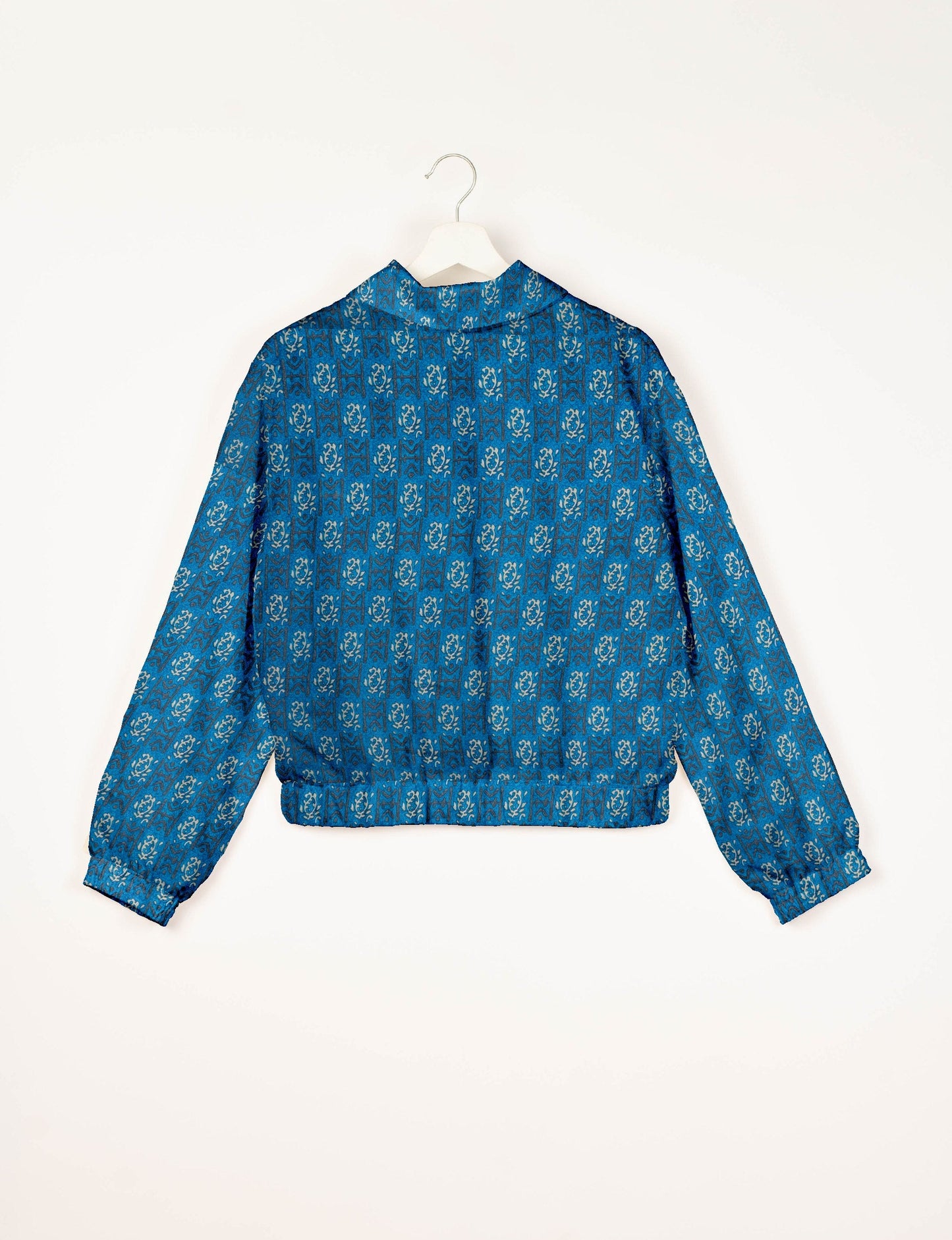 Upcycled Bomber Jacket made from recycled sari materials, featuring a cute cropped shape, elasticated hem and cuffs, and contrast sari print lining. Sustainable apparel promoting eco-friendly fashion and ethical clothing.