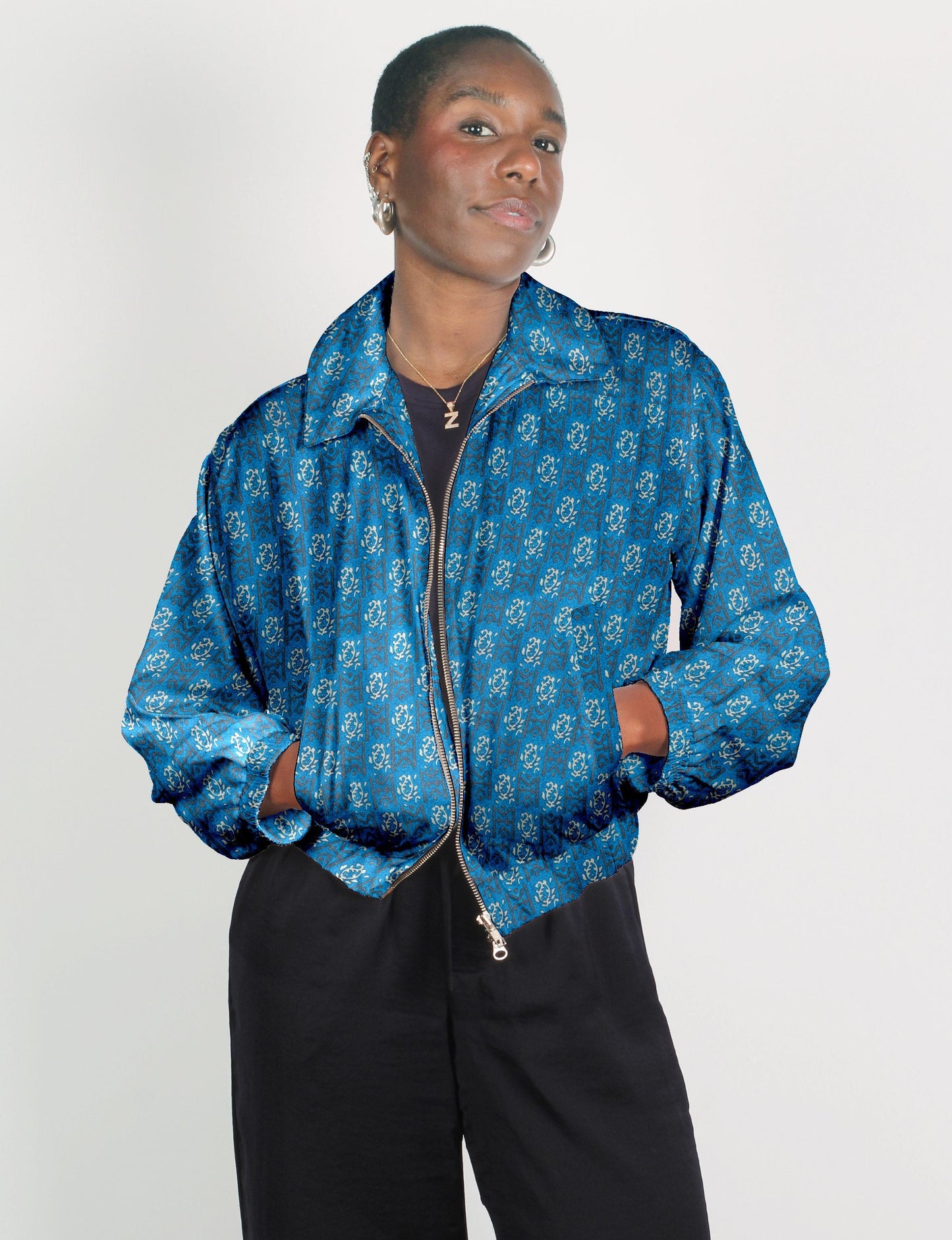 Upcycled Bomber Jacket made from recycled sari materials, featuring a cute cropped shape, elasticated hem and cuffs, and contrast sari print lining. Sustainable apparel promoting eco-friendly fashion and ethical clothing.