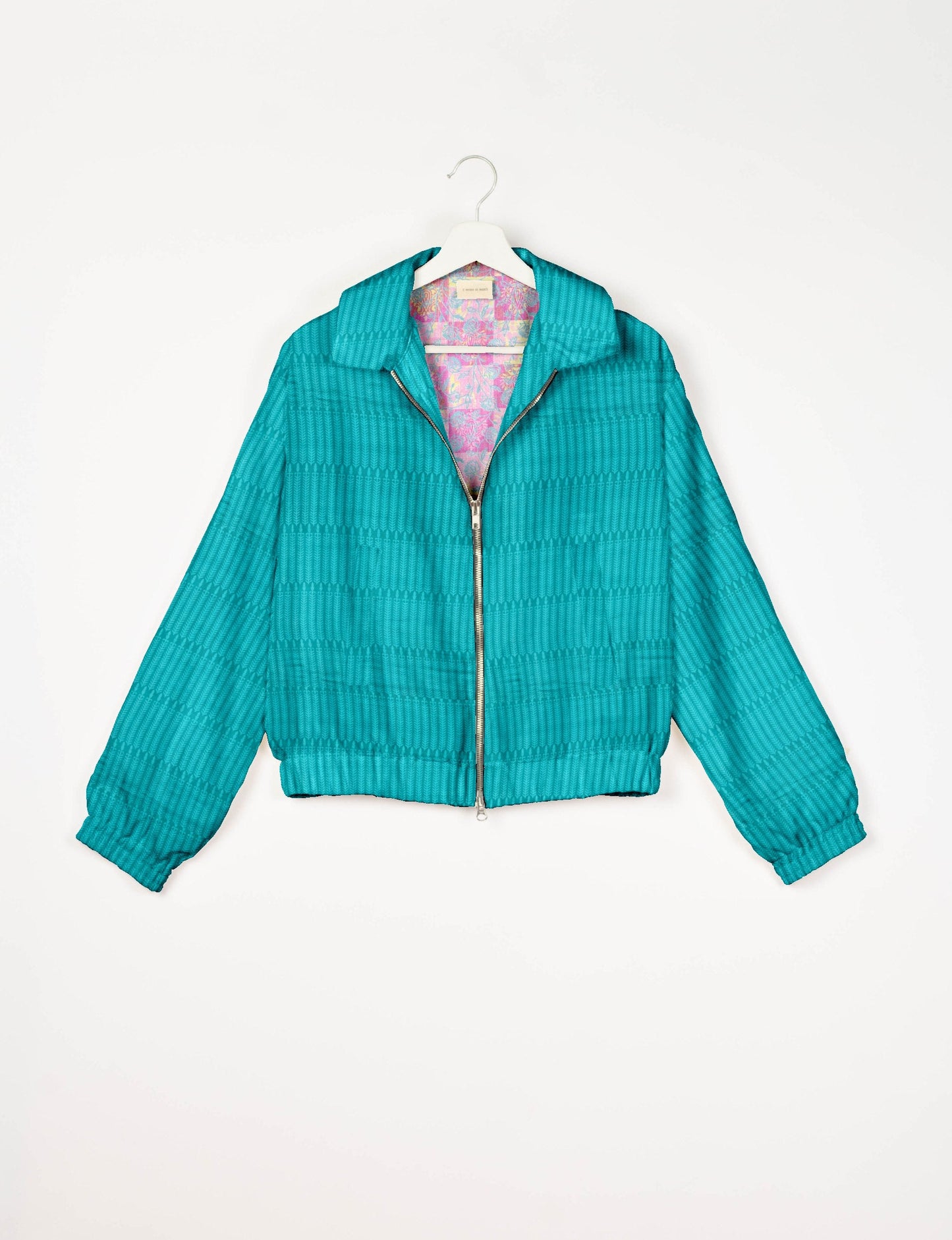 Upcycled Bomber Jacket made from recycled sari materials, featuring a cute cropped shape, elasticated hem and cuffs, and contrast sari print lining. Sustainable apparel promoting eco-friendly fashion and ethical clothing.