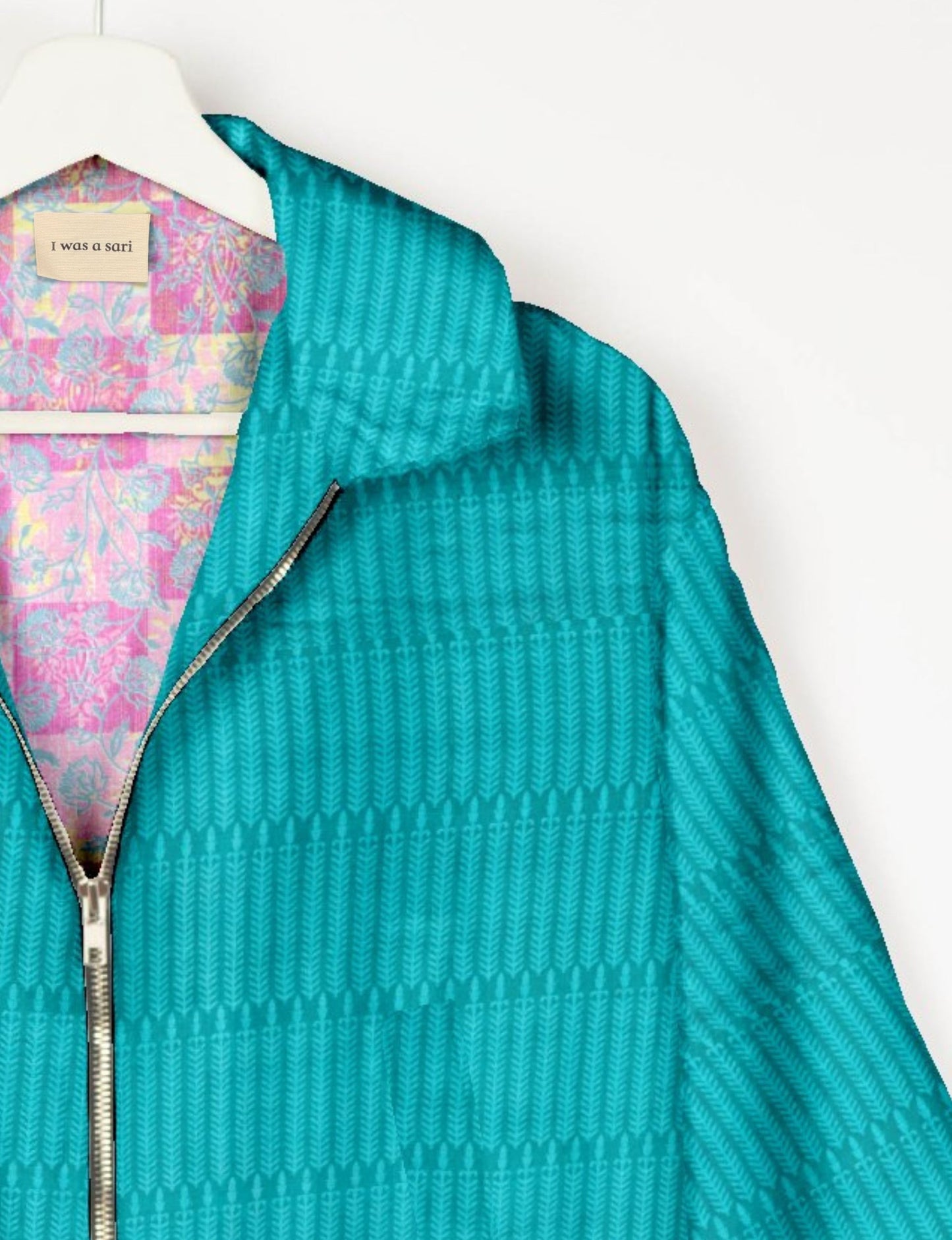 Upcycled Bomber Jacket made from recycled sari materials, featuring a cute cropped shape, elasticated hem and cuffs, and contrast sari print lining. Sustainable apparel promoting eco-friendly fashion and ethical clothing.