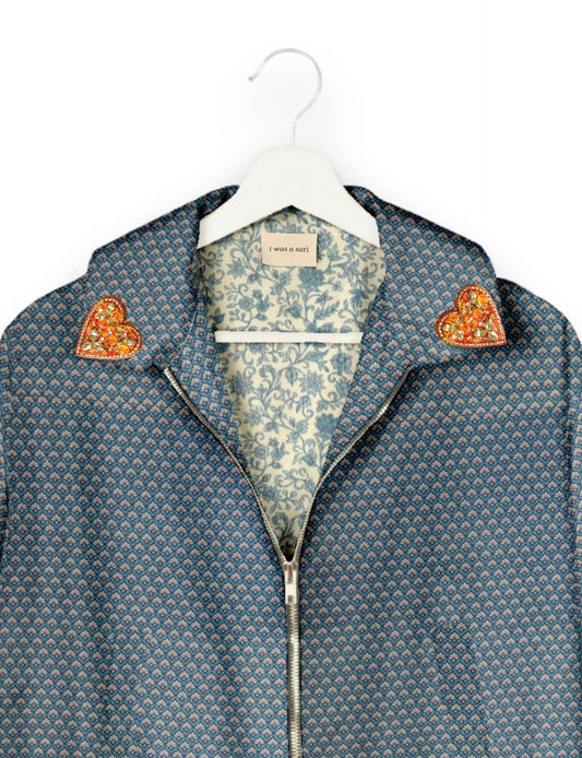 Make a bold statement with our Heart Drop Earrings, a symbol of conscious luxury and ethical fashion. Handcrafted using the intricate Aari embroidery technique, these earrings are made from upcycled sari fabric, embracing slow fashion and zero waste clothing. Elevate your look with sustainable apparel that supports fair trade fashion while reducing textile waste. Choose eco-friendly fashion that speaks of love, artistry, and responsibility.