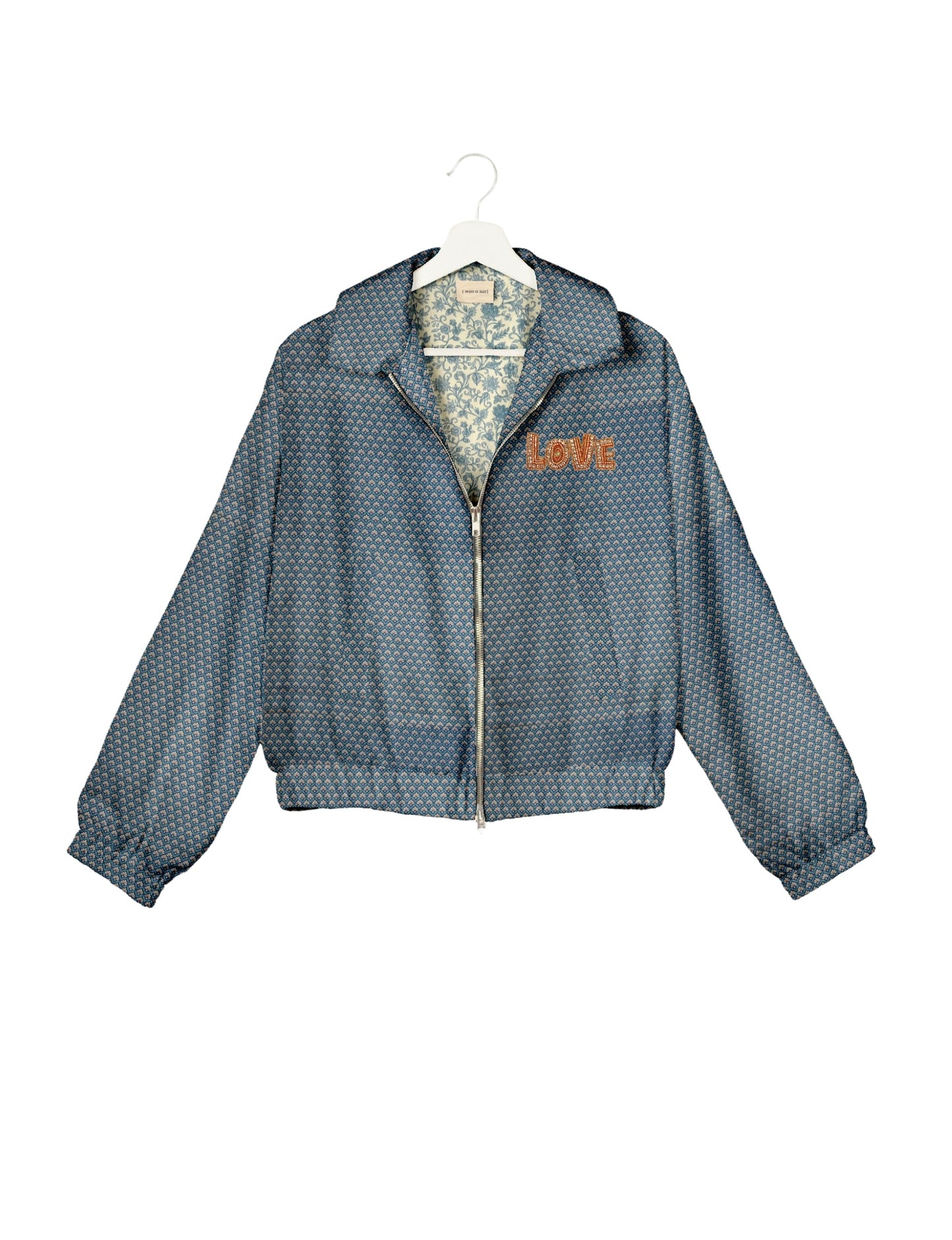 Love Bomber Jacket made from recycled fabric, featuring hand-stitched Aari embroidery. A unique piece of zero-waste clothing, part of the circular fashion movement. Designed with upcycled materials for a stylish yet environmentally friendly clothing choice.