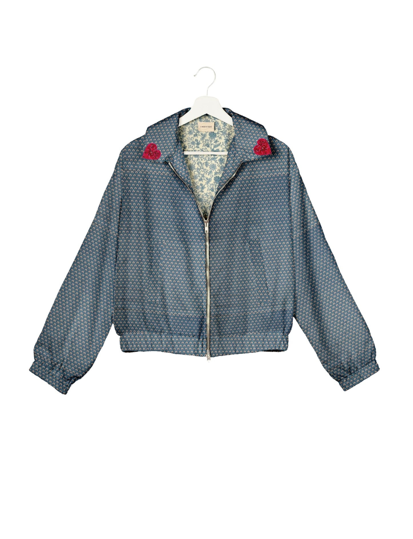 Make a bold statement with our Heart Drop Earrings, a symbol of conscious luxury and ethical fashion. Handcrafted using the intricate Aari embroidery technique, these earrings are made from upcycled sari fabric, embracing slow fashion and zero waste clothing. Elevate your look with sustainable apparel that supports fair trade fashion while reducing textile waste. Choose eco-friendly fashion that speaks of love, artistry, and responsibility.