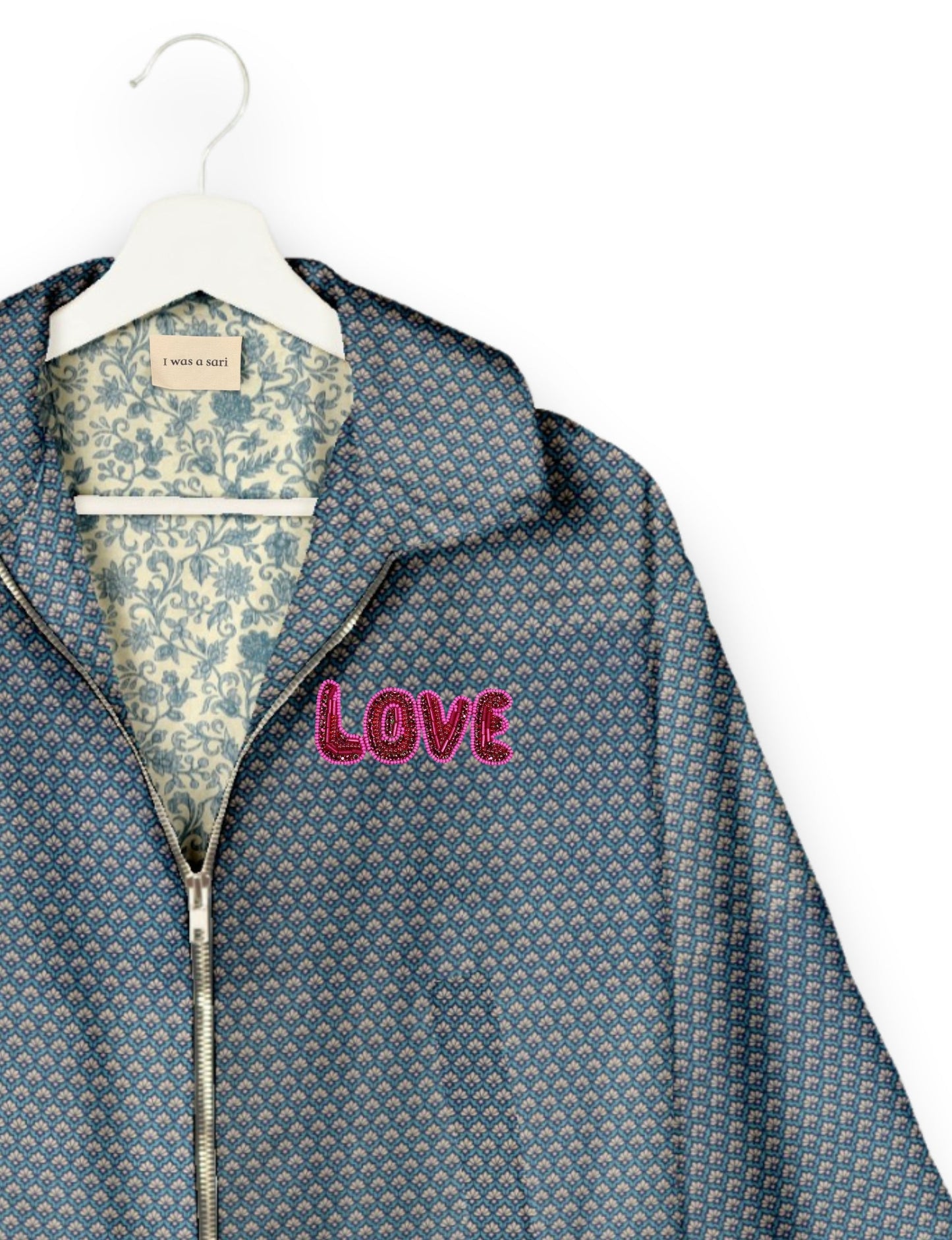 Love Bomber Jacket made from recycled fabric, featuring hand-stitched Aari embroidery. A unique piece of zero-waste clothing, part of the circular fashion movement. Designed with upcycled materials for a stylish yet environmentally friendly clothing choice.