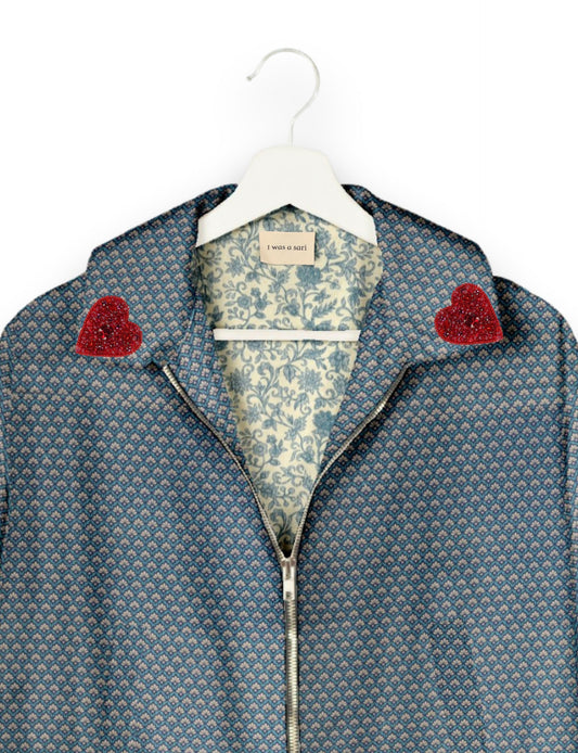 Make a bold statement with our Heart Drop Earrings, a symbol of conscious luxury and ethical fashion. Handcrafted using the intricate Aari embroidery technique, these earrings are made from upcycled sari fabric, embracing slow fashion and zero waste clothing. Elevate your look with sustainable apparel that supports fair trade fashion while reducing textile waste. Choose eco-friendly fashion that speaks of love, artistry, and responsibility.