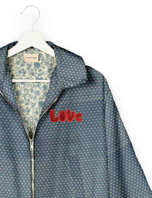 Love Bomber Jacket made from recycled fabric, featuring hand-stitched Aari embroidery. A unique piece of zero-waste clothing, part of the circular fashion movement. Designed with upcycled materials for a stylish yet environmentally friendly clothing choice.