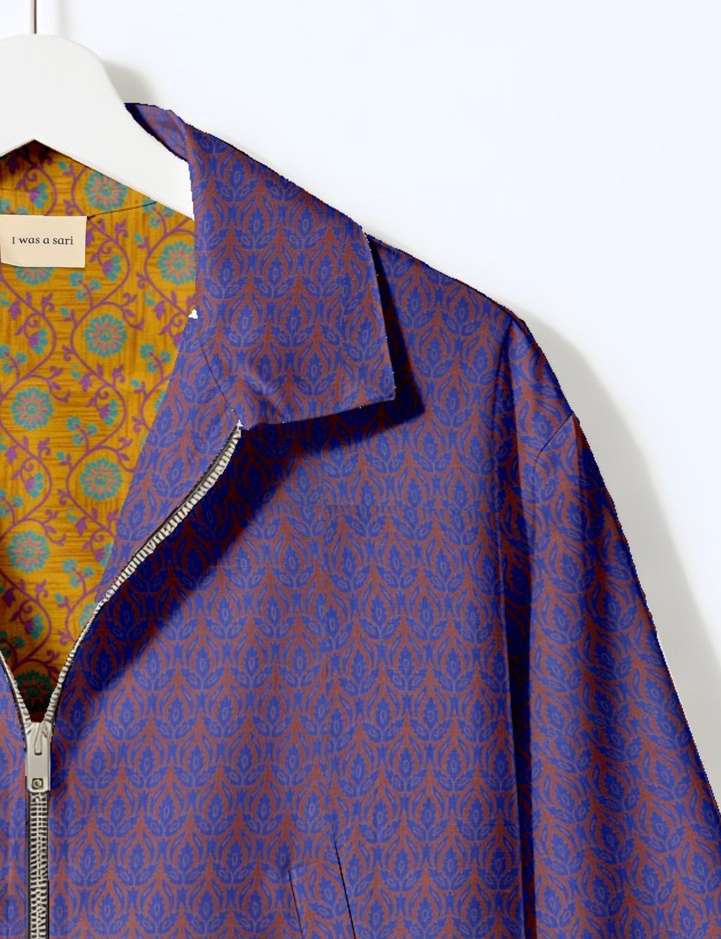 Upcycled Bomber Jacket made from recycled sari materials, featuring a cute cropped shape, elasticated hem and cuffs, and contrast sari print lining. Sustainable apparel promoting eco-friendly fashion and ethical clothing.