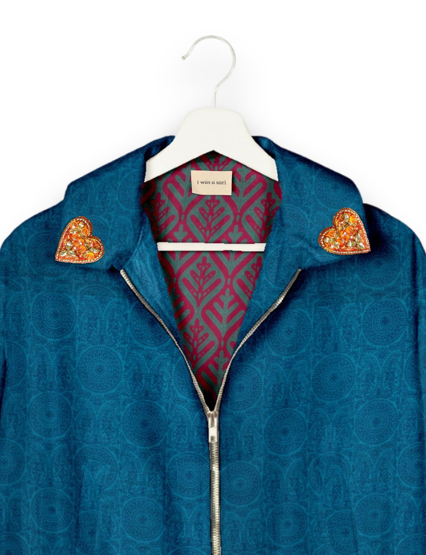 Make a bold statement with our Heart Drop Earrings, a symbol of conscious luxury and ethical fashion. Handcrafted using the intricate Aari embroidery technique, these earrings are made from upcycled sari fabric, embracing slow fashion and zero waste clothing. Elevate your look with sustainable apparel that supports fair trade fashion while reducing textile waste. Choose eco-friendly fashion that speaks of love, artistry, and responsibility.