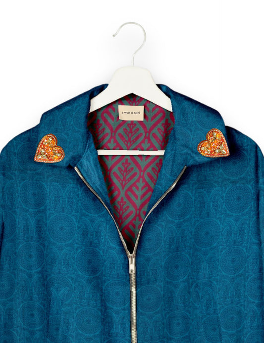 Make a bold statement with our Heart Drop Earrings, a symbol of conscious luxury and ethical fashion. Handcrafted using the intricate Aari embroidery technique, these earrings are made from upcycled sari fabric, embracing slow fashion and zero waste clothing. Elevate your look with sustainable apparel that supports fair trade fashion while reducing textile waste. Choose eco-friendly fashion that speaks of love, artistry, and responsibility.