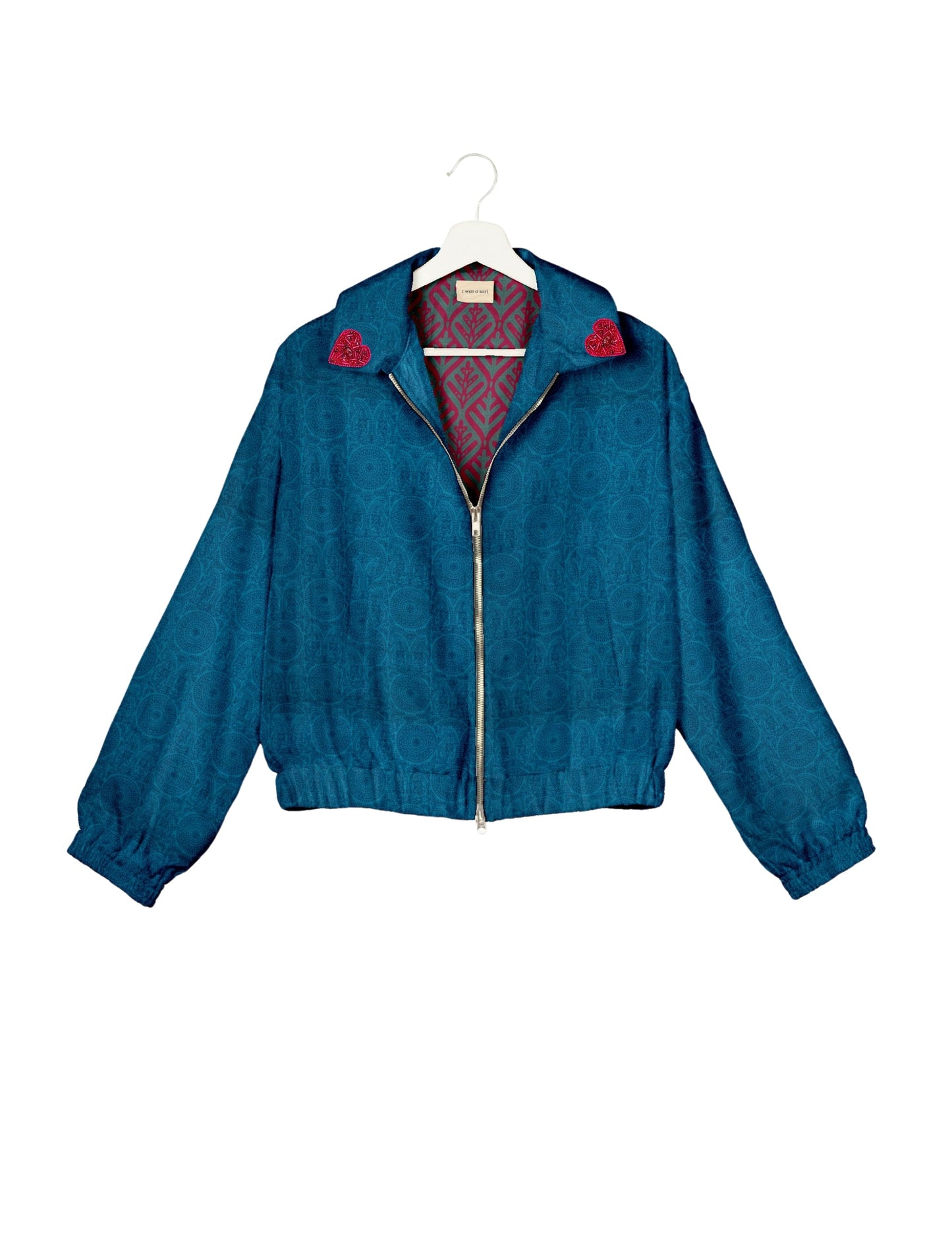 Make a bold statement with our Heart Drop Earrings, a symbol of conscious luxury and ethical fashion. Handcrafted using the intricate Aari embroidery technique, these earrings are made from upcycled sari fabric, embracing slow fashion and zero waste clothing. Elevate your look with sustainable apparel that supports fair trade fashion while reducing textile waste. Choose eco-friendly fashion that speaks of love, artistry, and responsibility.