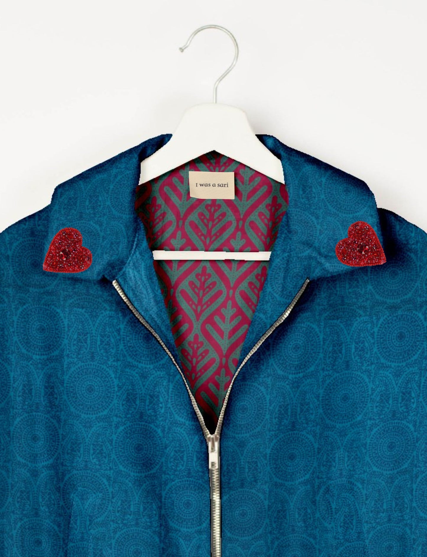 Make a bold statement with our Heart Drop Earrings, a symbol of conscious luxury and ethical fashion. Handcrafted using the intricate Aari embroidery technique, these earrings are made from upcycled sari fabric, embracing slow fashion and zero waste clothing. Elevate your look with sustainable apparel that supports fair trade fashion while reducing textile waste. Choose eco-friendly fashion that speaks of love, artistry, and responsibility.