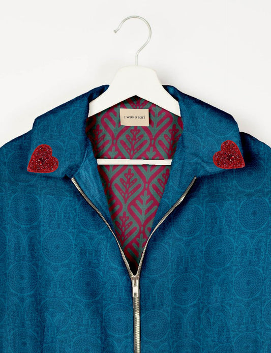 Make a bold statement with our Heart Drop Earrings, a symbol of conscious luxury and ethical fashion. Handcrafted using the intricate Aari embroidery technique, these earrings are made from upcycled sari fabric, embracing slow fashion and zero waste clothing. Elevate your look with sustainable apparel that supports fair trade fashion while reducing textile waste. Choose eco-friendly fashion that speaks of love, artistry, and responsibility.