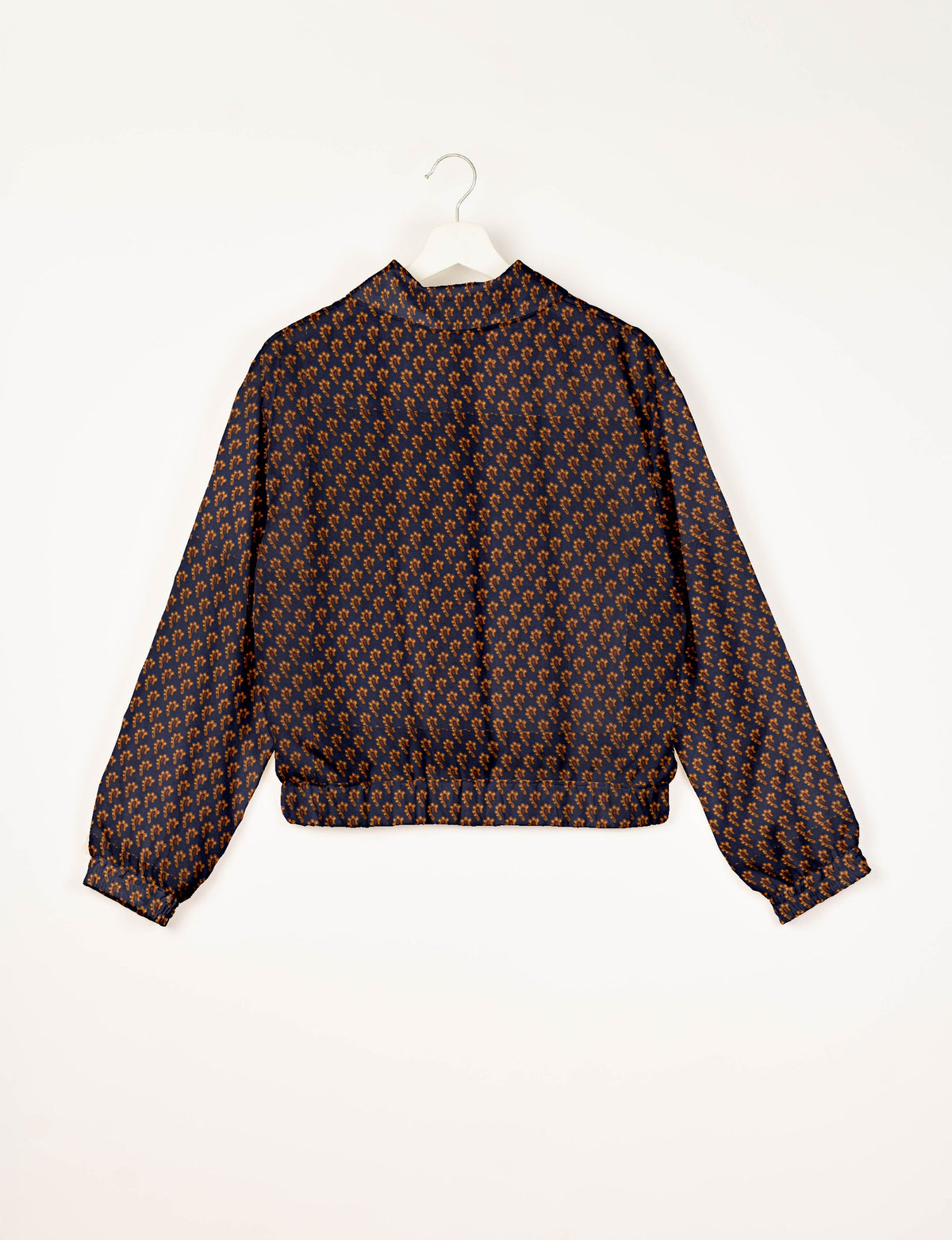 Blue bomber jacket with brown micro pattern, elastic cuffs and waistband, shown from back on white hanger